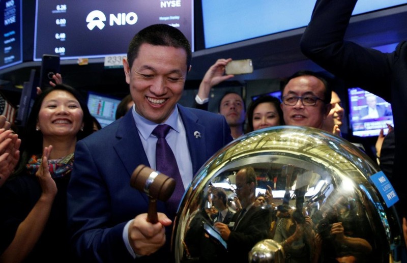 William Li rings a ceremonial bell as NIO's stock begins trading on the New York Stock Exchange (NYSE) 